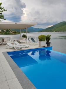 a swimming pool with a view of the water at Villa Tikvesh Lake in Kavadarci