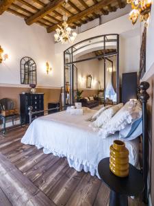 a bedroom with a large bed with a large mirror at Palazzo Ravenna in Ravenna