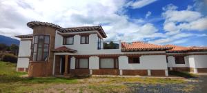 a large white house with a red roof at Casas Villa de Leyva in Villa de Leyva