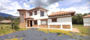 a house in the middle of a field at Casas Villa de Leyva in Villa de Leyva