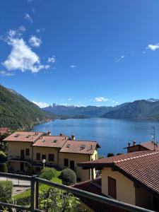 a view of a lake with houses and mountains at Charming & bright apartment Como lakefront in Argegno +12 photos