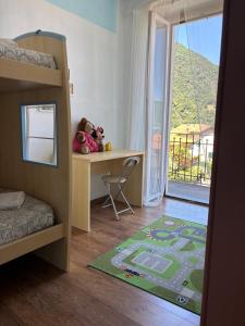 a bedroom with a bunk bed with two stuffed animals on a desk at Charming & bright apartment Como lakefront in Argegno