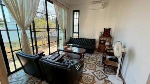 a living room with a couch and a table at Home No 5 in Ratchaburi