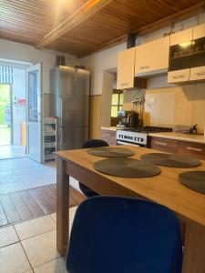 a kitchen with a table with chairs and a refrigerator at Tleniowo in Tleń