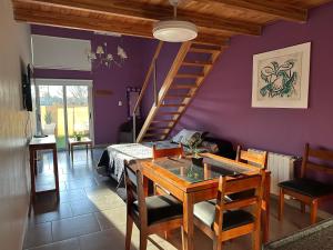 a living room with a table and a staircase at Centro Apart in Villa Elisa +16 photos