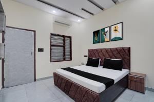 a bedroom with a large bed in a room at Hotel O The Signature Residency in Rohtak
