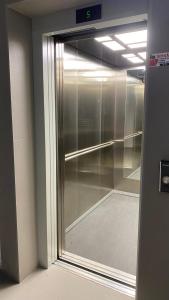 a sliding glass door of a walk in closet at Ayzal Apartment in Shëngjin