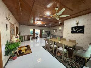 a dining room with a ceiling fan and a table at SKYmount in Murree