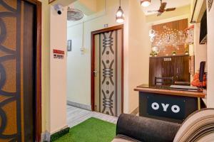 a room with a door and a couch and a table at Hotel O White Sapphire in Jādabpur