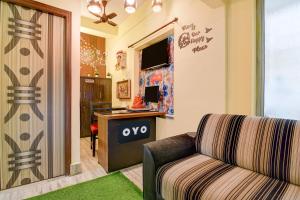 a living room with a couch and a desk at Hotel O White Sapphire in Jādabpur
