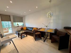a living room with a couch and a table at Blue Mare BB in Łukęcin