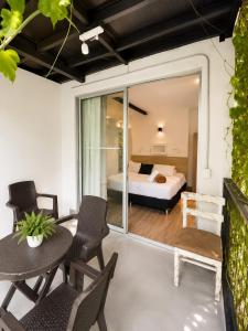 a room with a bed and a table and chairs at Carriqui Garden Hotel in Pereira
