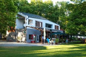 a building in a park with people in the grass at Villa Mango 2 in Balatongyörök