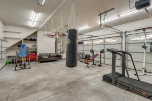 a fitness room with a gym with a punching bag at Pool Table & Home Gym! Manteca Group Getaway in Manteca
