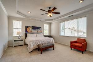a bedroom with a bed and a ceiling fan and a chair at Pool Table & Home Gym! Manteca Group Getaway in Manteca