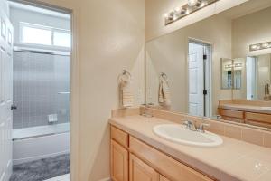 a bathroom with a sink and a shower and a mirror at Pool Table & Home Gym! Manteca Group Getaway in Manteca +22 photos