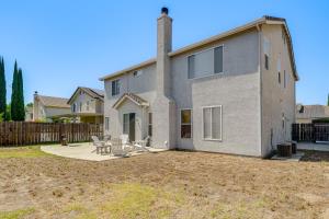 a house with a table and chairs in a yard at Pool Table & Home Gym! Manteca Group Getaway in Manteca