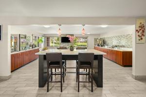 a kitchen with a large kitchen island with chairs at Red Roof Inn & Suites Marysville in Marysville