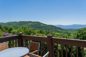 a balcony with a table and chairs and mountains at Massanutten Resort in Massanutten