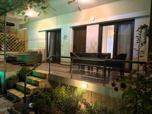 a house with a patio with chairs and a pond at My Afytos Garden in Afitos