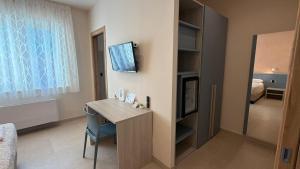 a room with a desk and a room with a bed at B&B Capo Vaticano Stay in Capo Vaticano