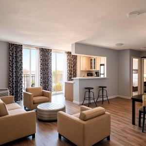 a living room with a couch and chairs and a kitchen at Silver Beach Hotel in Saint Joseph