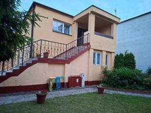 a house with a staircase in front of it at Dom Wczasowy Jędrek pokoje in Niechorze