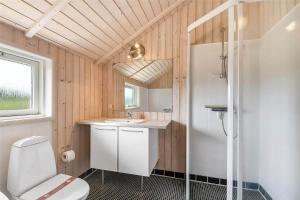 a bathroom with a toilet and a sink and a shower at 507-Lemvig-Lyngsletten-11 in Lemvig +10 photos