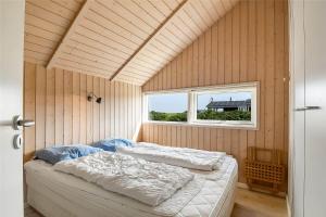 a bedroom with two beds in a room with a window at 507-Lemvig-Lyngsletten-11 in Lemvig