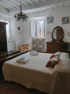 a bedroom with a large bed with two towels on it at Dimora Frasassi - Genga in Genga