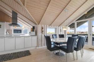 a kitchen and dining room with a table and chairs at 507-Lemvig-Lyngsletten-11 in Lemvig