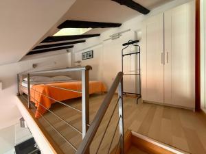 a bedroom with an orange bed in a loft at Downtown Apartments Pula in Pula
