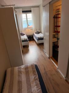 a bedroom with a bed and a room with a window at Trehörna Wärdshus & Hotell in Trehörna