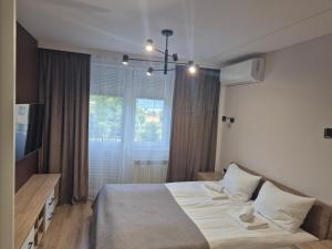 a bedroom with a bed and a large window at Słoneczna 3m5 in Gorlice
