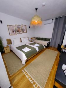 a bedroom with a large bed and two rugs at Garden Relax Bungalow "Deluxe Hotel Rooms, Pool, Parking" in Banja Luka +62 photos