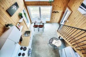 an overhead view of a kitchen and dining room in a tiny house at Lake Hideaway with BBQ, Fire Pit & Horses in Sainte-Marguerite