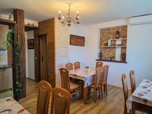 a kitchen and dining room with a table and chairs at Guest House Bunčić Rooms & Apartments in Slunj