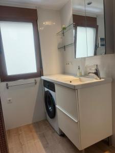 a kitchen with a washing machine and a sink at Loft Adrimar in Santoña +16 photos