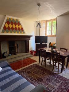 a living room with a table and a fireplace at Casa Fulvia by Lago Maggiore Rentals & Estate in Cannobio