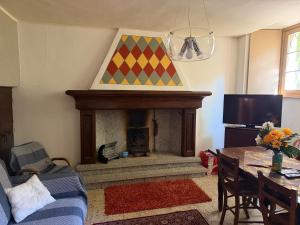 a living room with a fireplace and a table at Casa Fulvia by Lago Maggiore Rentals & Estate in Cannobio