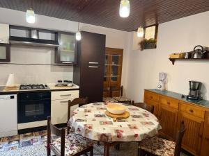a kitchen with a table and some chairs and a kitchen with a stove at Casa Fulvia by Lago Maggiore Rentals & Estate in Cannobio
