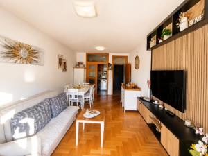 a living room with a couch and a tv at SeaSideApartman3 in Budva