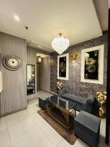 a living room with a couch and a chandelier at Luxury sup nova in New Delhi +20 photos