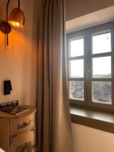 a bedroom with a window and a dresser and a table at Pirrion Villas in Ano Pedina +20 photos