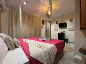 a bedroom with a bed with a red blanket at Explore Pyramids View in Cairo