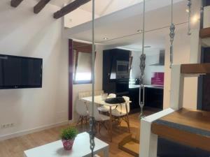 a living room with a table and a dining room at Loft Adrimar in Santoña