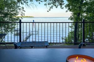 a table with a bench and a view of the water at Waterfront Leech Lake Cabin: Dock, Fire Pit, Deck in Cass Lake