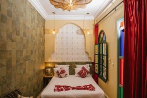 a bedroom with a bed with a bow tie on it at The Little Hara in Marrakesh +10 photos