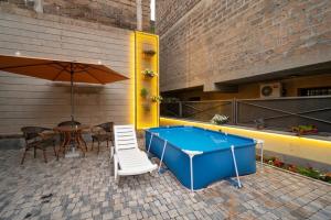 a pool table and chairs and an umbrella on a patio at Kaskade House in Yerevan
