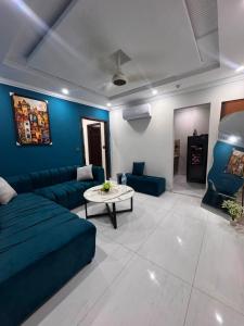 a living room with a couch and a table at Shazi Heights in Lahore